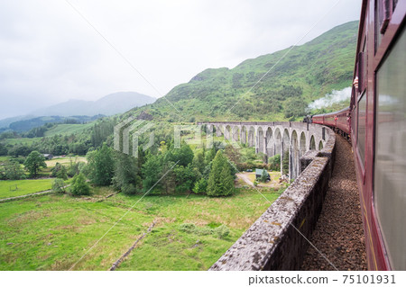 Jacobite Steam Train Locomotive passing Glenfinnan Viaduct Jacobite Steam Train Locomotive passing Glenfinnan Viaduct 75101931