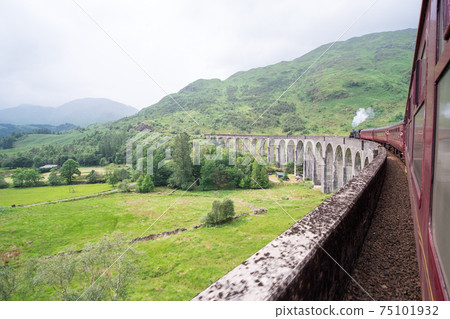 Jacobite Steam Train Locomotive passing Glenfinnan Viaduct Jacobite Steam Train Locomotive passing Glenfinnan Viaduct 75101932