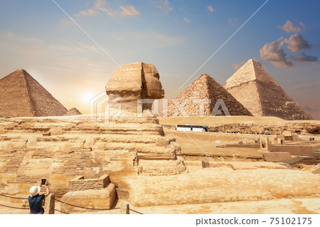 A tourist in Giza enjoying the Sphinx and the Pyramids, Egypt 75102175