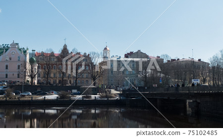 Beautiful houses and a bridge over the river. The city of Vyborg. Beautiful houses and a bridge over the river. The city of Vyborg. 75102485