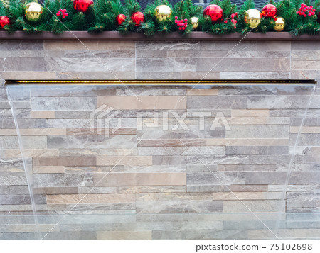 Transparent waterfall from the wall decorated with artificial spruce and red balls Transparent waterfall from the wall decorated with artificial spruce and red balls 75102698