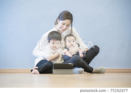 Parents and children enjoying online communication using a tablet PC 75102877