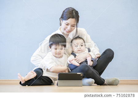 Parents and children enjoying online communication using a tablet PC Parents and children enjoying online communication using a tablet PC 75102878