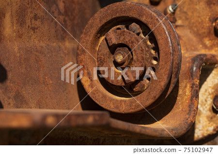 Rusty metal parts of an old and abandoned tractor, Aragon, Spain. Rusty metal parts of an old and abandoned tractor, Aragon, Spain. 75102947