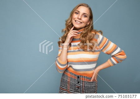 Young charming fascinating sexy positive happy smiling blonde woman wearing casual striped pullover Young charming fascinating sexy positive happy smiling blonde woman wearing casual striped pullover 75103177