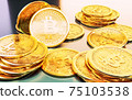 Cryptocurrency Bitcoin golden coins spilling on the table. 75103538
