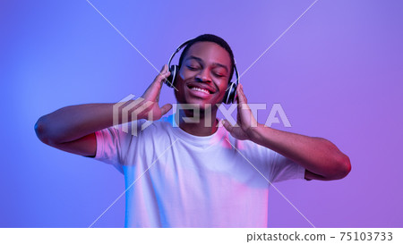 Music Streaming Services. Portraif Of Smiling Black Guy In Wireless Headphones 75103733