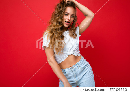 Young beautiful curly blonde woman with sexy expression, cheerful and happy face wearing casual 75104510