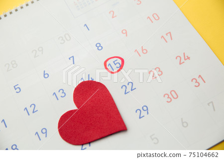 Red heart with red highlighter with ovulation day mark on calendar. Gynecology concept Red heart with red highlighter with ovulation day mark on calendar. Gynecology concept 75104662