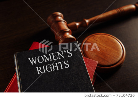 Woman's rights book at the desk. Protecting female concept. 75104726