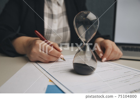 Close up on woman's notary public hand stamping the document. Notary public concept Close up on woman's notary public hand stamping the document. Notary public concept 75104800