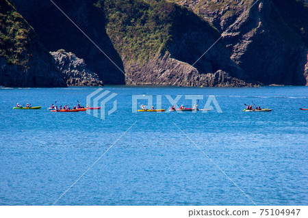 Photograph of sea kayaking touring the sea in a group Blue sea marine sports Photograph of sea kayaking touring the sea in a group Blue sea marine sports 75104947