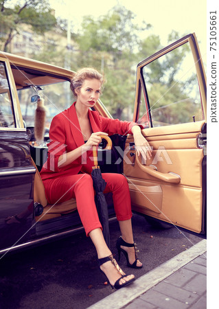 Beautiful young woman in retro car Beautiful young woman in retro car 75105661