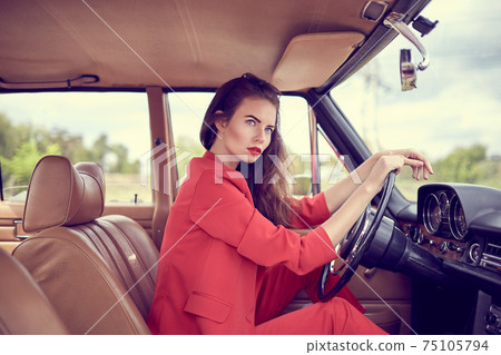 Beautiful young woman in retro car Beautiful young woman in retro car 75105794