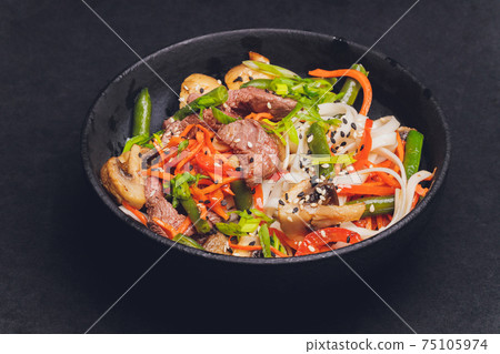 Udon noodles with chicken and peppers - Japanese cuisine. Udon noodles with chicken and peppers - Japanese cuisine. 75105974