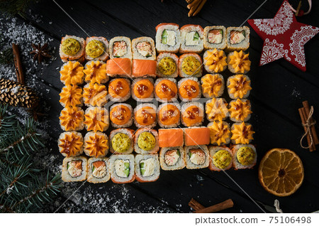 sushi set and sushi roll on wooden board. sushi set and sushi roll on wooden board. 75106498