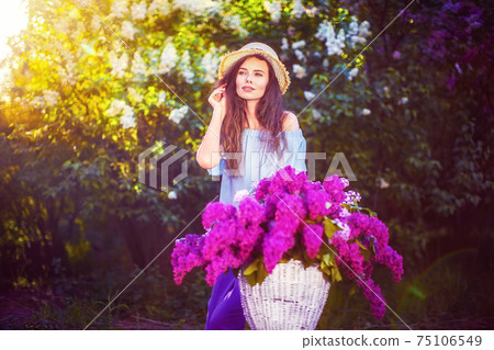 beautiful young girl with vintage bicycle and flowers on city ba 75106549