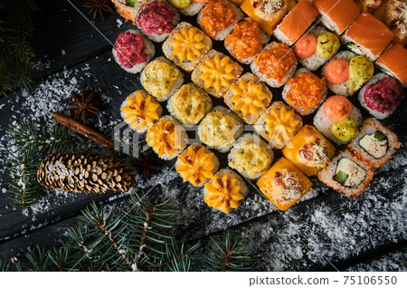 sushi set and sushi roll on wooden board. 75106550