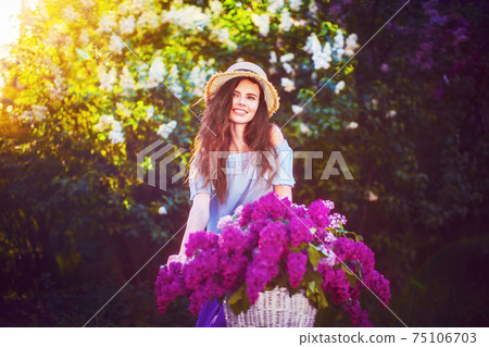 beautiful young girl with vintage bicycle and flowers on city ba 75106703