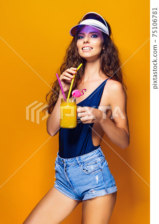 Sexy Woman in white swimsuit and blue jeans shorts, trendy visor 75106781