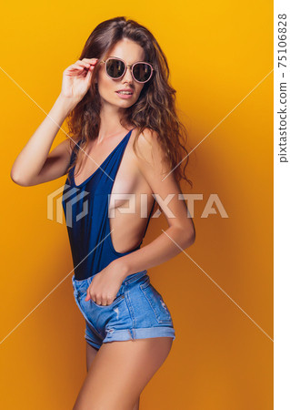 Woman wearing lingerie and sunglasses Woman wearing lingerie and sunglasses 75106828