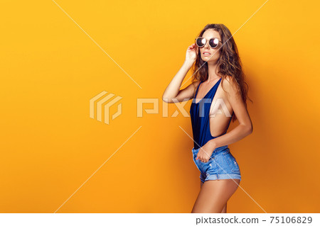 Woman wearing lingerie and sunglasses Woman wearing lingerie and sunglasses 75106829
