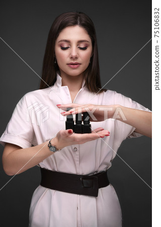 Manicurist in working form with tools in hand. Nail photo content 75106832