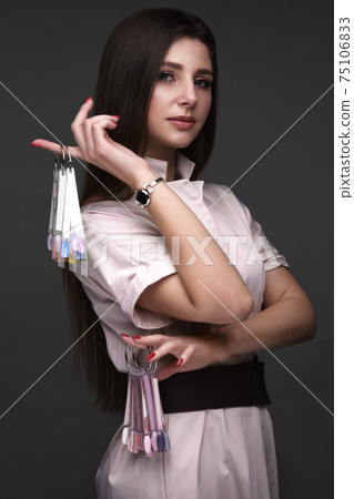 Manicurist in working form with tools in hand. Nail photo content Manicurist in working form with tools in hand. Nail photo content 75106833