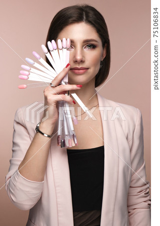 Manicurist in working form with tools in hand. Nail photo content Manicurist in working form with tools in hand. Nail photo content 75106834