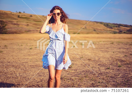 beautiful young woman outdoor on the hill on a summer day beautiful young woman outdoor on the hill on a summer day 75107261