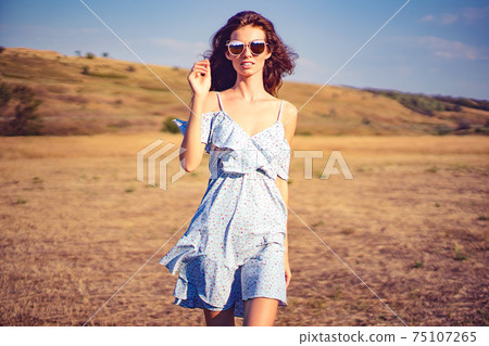 beautiful young woman outdoor on the hill on a summer day beautiful young woman outdoor on the hill on a summer day 75107265