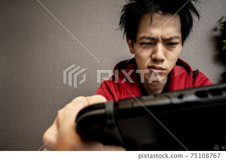 Young man addicted to video games, young Asian man with sleeping habits, young man crazy about games, Young man addicted to video games, young Asian man with sleeping habits, young man crazy about games, 75108767