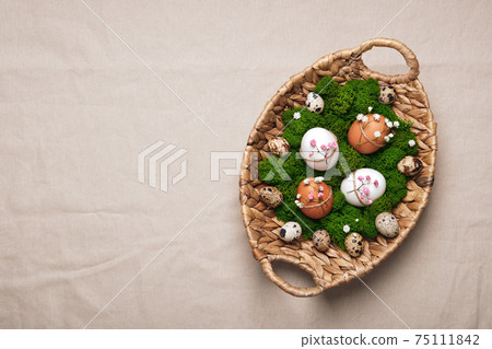 Easter eggs with natural flowers decor on linen tablecloth. Zero Waste Easter, copy space 75111842