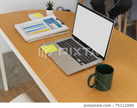 Office desk with laptop, business paperwork, mug and supplies in office room Office desk with laptop, business paperwork, mug and supplies in office room 75112880