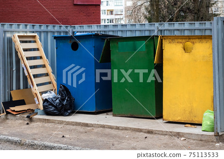 Three large colored trash bins and trash bags Three large colored trash bins and trash bags 75113533
