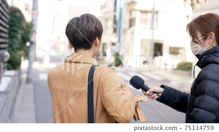 A woman undergoing a street interview 75114759