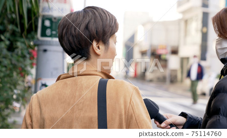 A woman undergoing a street interview A woman undergoing a street interview 75114760