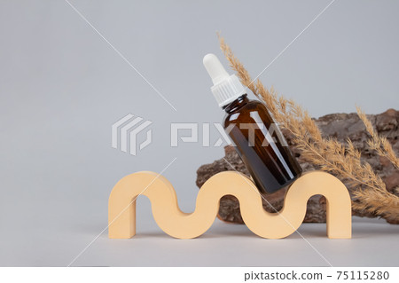 Mockup image of dropper bottle with modern organic cosmetics - polyglutamic or hyaluronic acid, serum, moisturizer, facial anti-aging oil. Trendy still life composition with natural bark elements Mockup image of dropper bottle with modern organic cosmetics - polyglutamic or hyaluronic acid, serum, moisturizer, facial anti-aging oil. Trendy still life composition with natural bark elements 75115280
