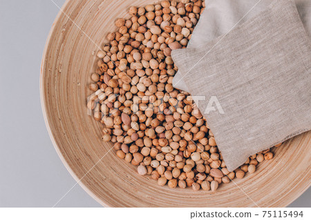 Cherry stone pillows in a bowl with cherry stones, cherry pit filled pillow for spa massage - natural heat or cool pack. Alternative medicine and therapy, pit sack for chiropractic care. Mockup Cherry stone pillows in a bowl with cherry stones, cherry pit filled pillow for spa massage - natural heat or cool pack. Alternative medicine and therapy, pit sack for chiropractic care. Mockup 75115494