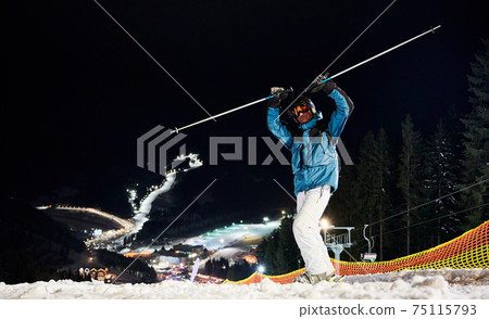 Skier in high mountains at night at ski resort Skier in high mountains at night at ski resort 75115793