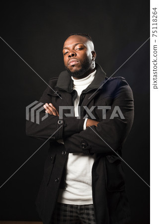 Black man, very serious and with his arms crossed. Black man, very serious and with his arms crossed. 75118264