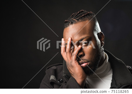 Bored and half asleep black man with his hand on his face. Bored and half asleep black man with his hand on his face. 75118265