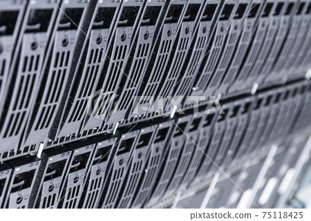 Cluster of data storage hard drives inside server room 75118425