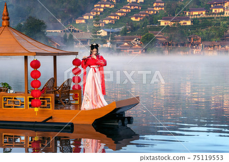 Asian woman wearing chinese traditional dress on Yunan boat at Ban rak thai village in mae hong son province, Thailand. 75119553