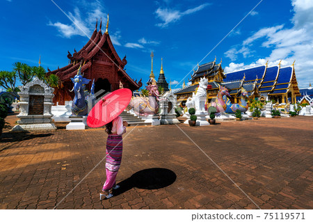 Asian women wearing Thai dress costume traditional according Thai culture at temple in Chiang Mai. Asian women wearing Thai dress costume traditional according Thai culture at temple in Chiang Mai. 75119571