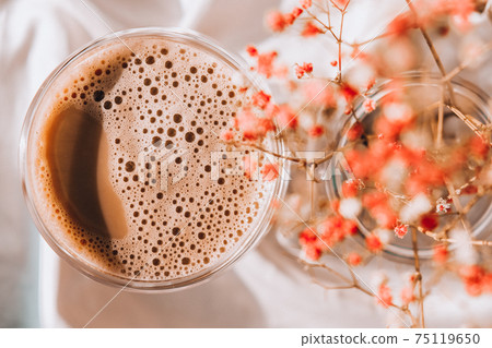 Cup of latte cappuccino. Morning coffee aesthetics vibes. Breakfast. Pink gypsophila flowers 75119650