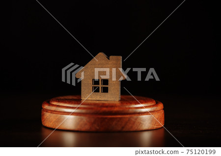 Mortgage concept. Wooden gavel and house at the desk. Mortgage concept. Wooden gavel and house at the desk. 75120199
