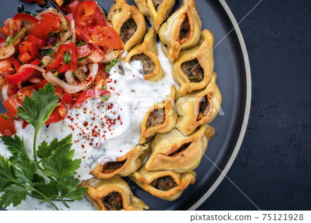 Traditional Armenian manti with mincemeat and paprika tomato salad Traditional Armenian manti with mincemeat and paprika tomato salad 75121928