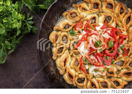 Traditional Armenian manti with mincemeat and paprika tomato salad 75121937