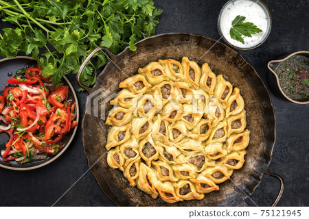 Traditional Armenian manti oven backed with mincemeat  75121945